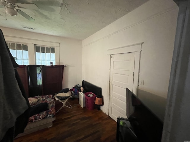 miscellaneous room with a textured ceiling, dark hardwood / wood-style flooring, and ceiling fan