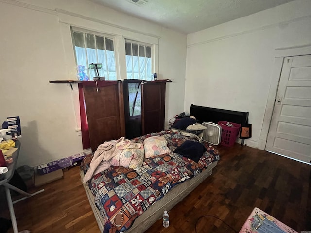 bedroom featuring dark hardwood / wood-style floors