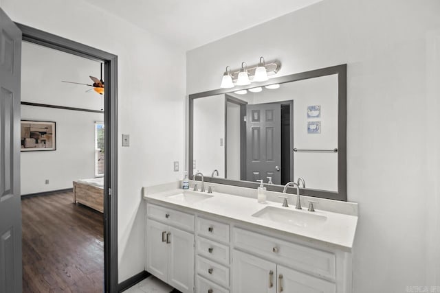 bathroom with wood-type flooring, vanity, and ceiling fan