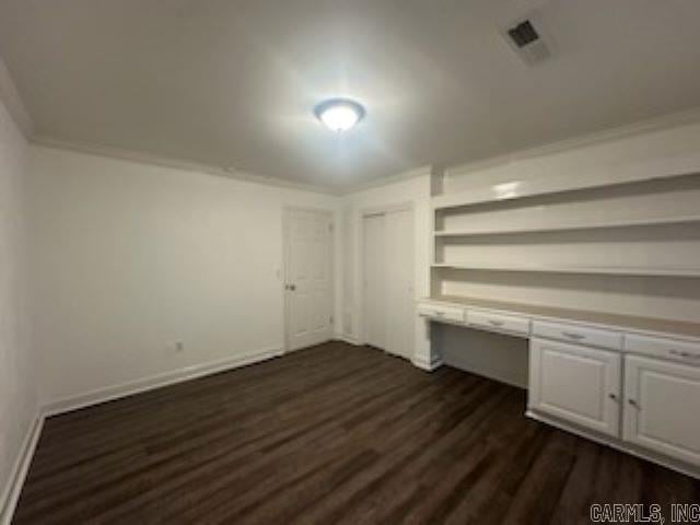 interior space featuring dark hardwood / wood-style floors and crown molding