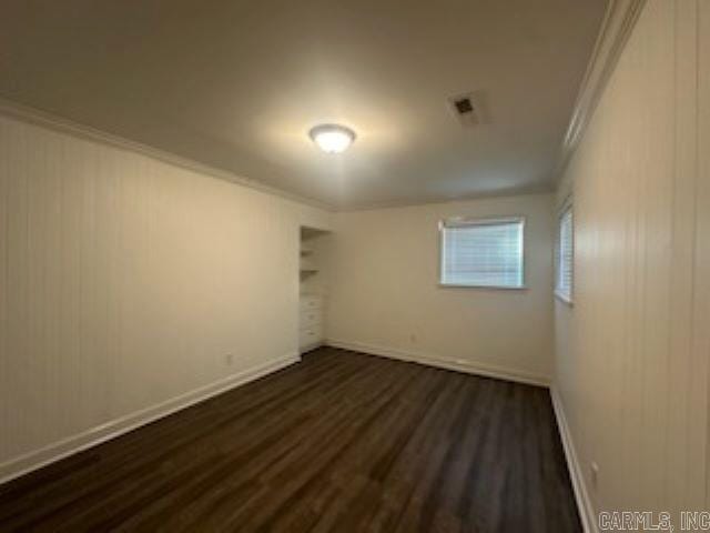 unfurnished bedroom with crown molding, a closet, and dark hardwood / wood-style floors