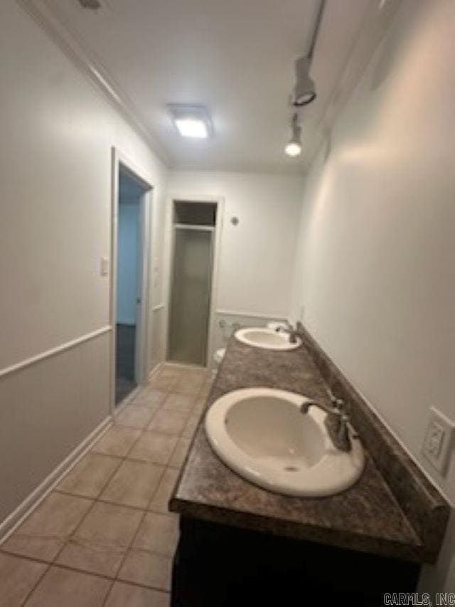 bathroom featuring tile patterned floors, vanity, crown molding, and track lighting