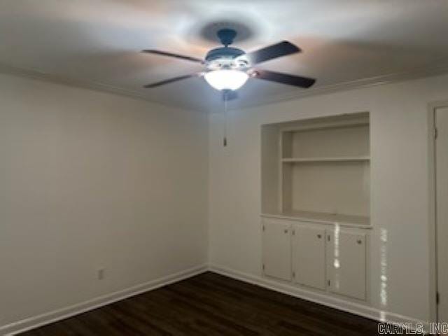 spare room with dark hardwood / wood-style floors and ceiling fan