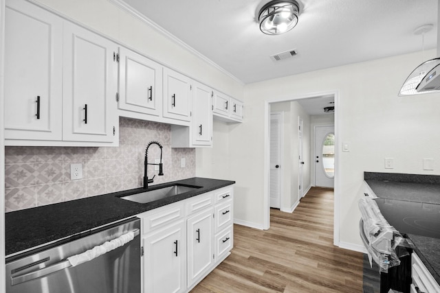 kitchen featuring stove, sink, stainless steel dishwasher, light hardwood / wood-style floors, and white cabinetry