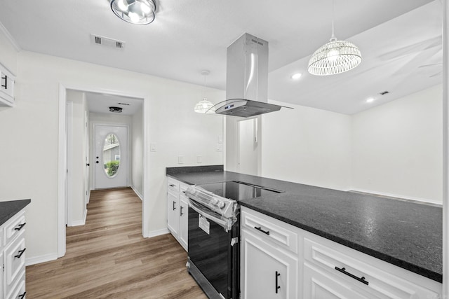 kitchen with stainless steel electric stove, pendant lighting, white cabinetry, and island exhaust hood