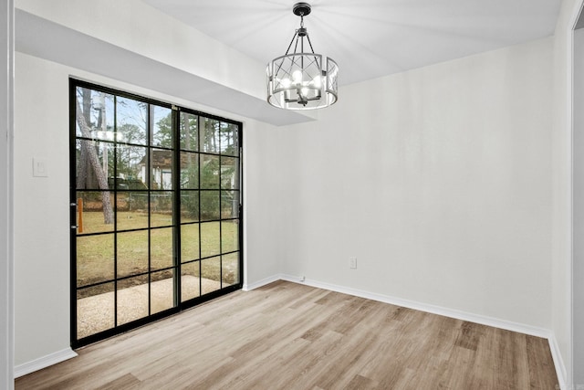 unfurnished dining area with light hardwood / wood-style flooring and an inviting chandelier