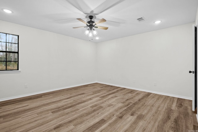 empty room with light wood-type flooring and ceiling fan