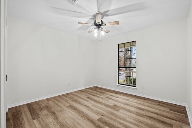 spare room featuring light hardwood / wood-style floors and ceiling fan