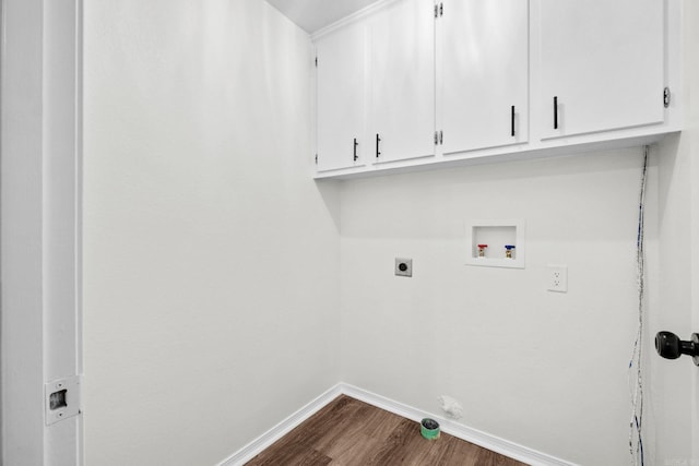 laundry room with electric dryer hookup, dark hardwood / wood-style flooring, cabinets, and washer hookup