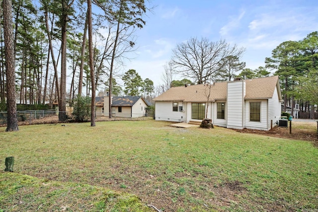 back of house with a yard