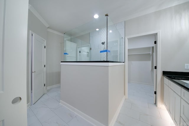 bathroom featuring a shower, crown molding, and vanity