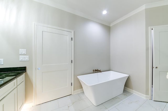 bathroom featuring vanity, ornamental molding, and a tub