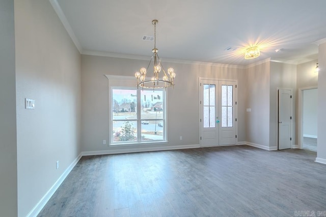 unfurnished room featuring crown molding, french doors, hardwood / wood-style floors, and a notable chandelier