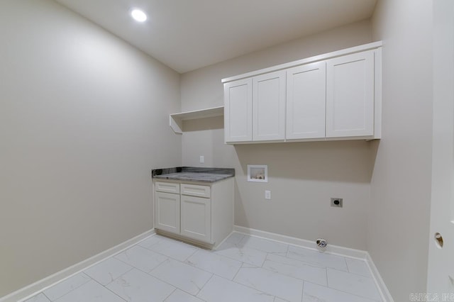 clothes washing area with hookup for an electric dryer, cabinets, and washer hookup