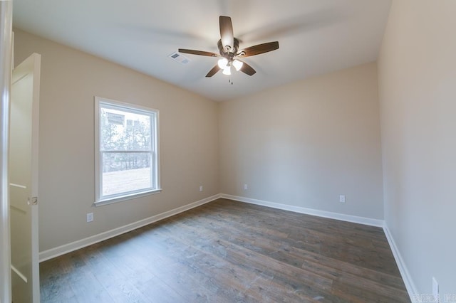 empty room featuring dark hardwood / wood-style flooring and ceiling fan