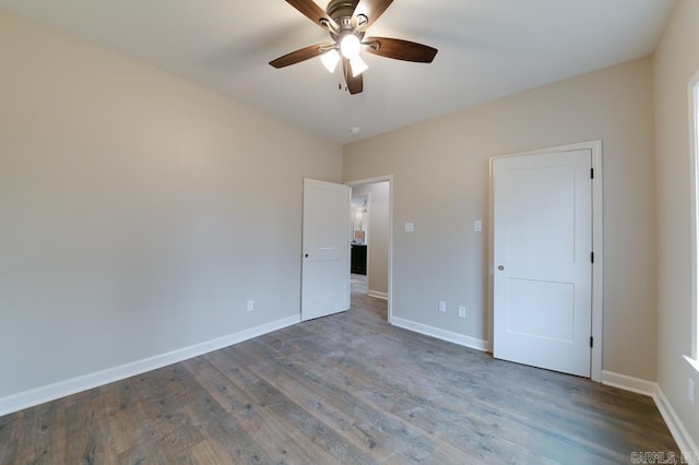 unfurnished bedroom featuring ceiling fan and dark hardwood / wood-style floors