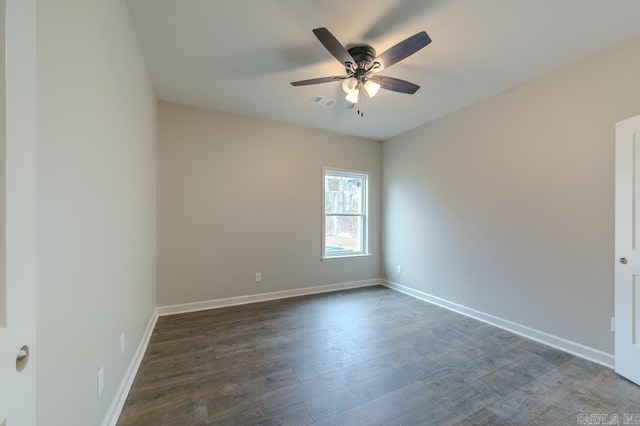 spare room with ceiling fan and dark wood-type flooring