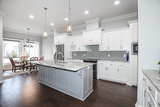 kitchen with a center island with sink, white cabinetry, and appliances with stainless steel finishes