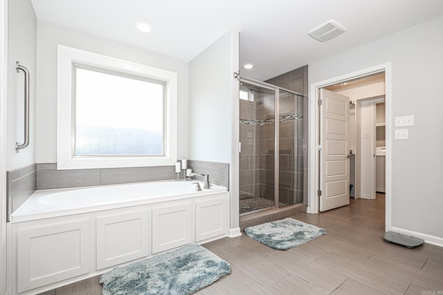 bathroom featuring separate shower and tub