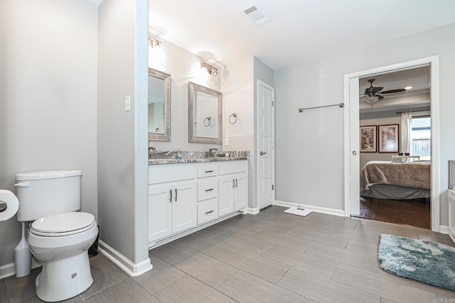 bathroom with ceiling fan, toilet, and vanity