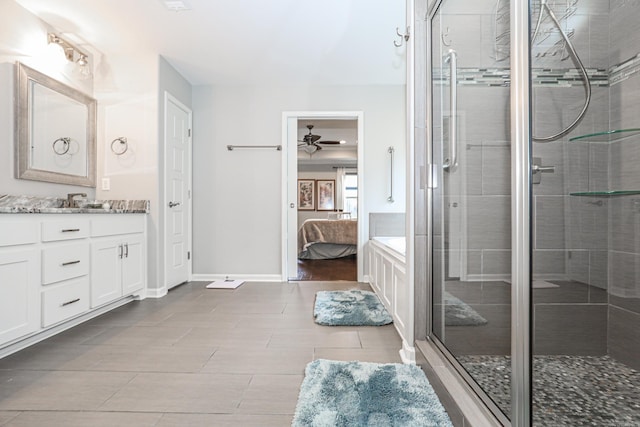 bathroom with tile patterned flooring, vanity, an enclosed shower, and ceiling fan