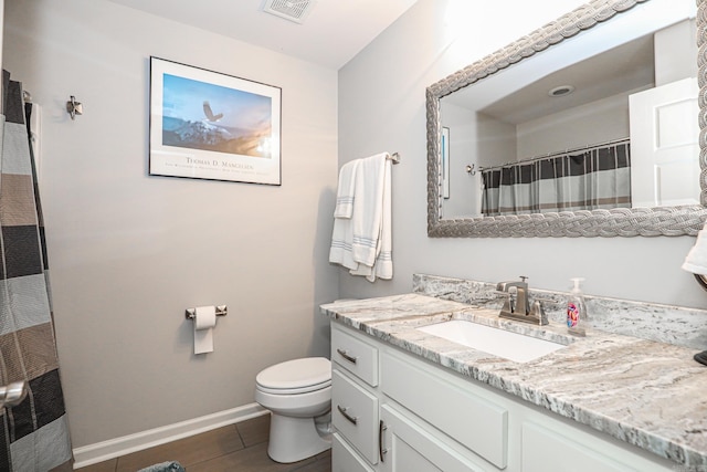 bathroom with vanity, toilet, and curtained shower