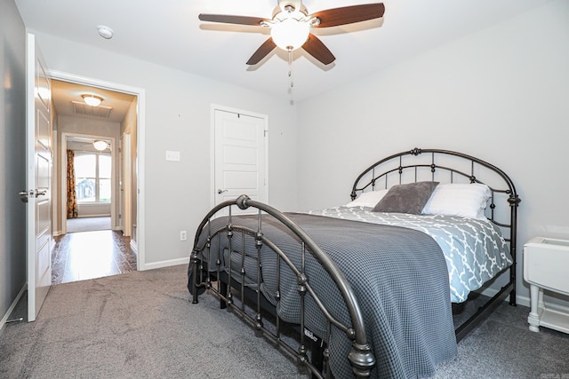 bedroom featuring ceiling fan and carpet