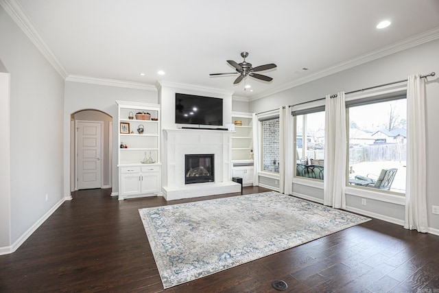 unfurnished living room featuring ceiling fan, dark hardwood / wood-style flooring, and ornamental molding