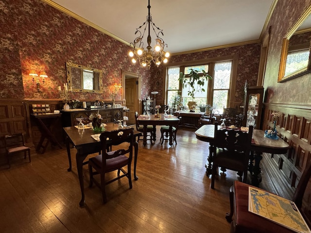 dining space featuring hardwood / wood-style flooring, a chandelier, and ornamental molding