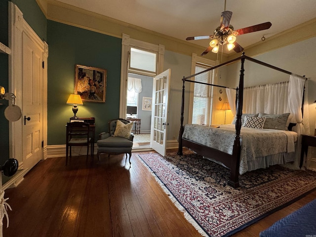 bedroom featuring multiple windows, ceiling fan, hardwood / wood-style floors, and crown molding