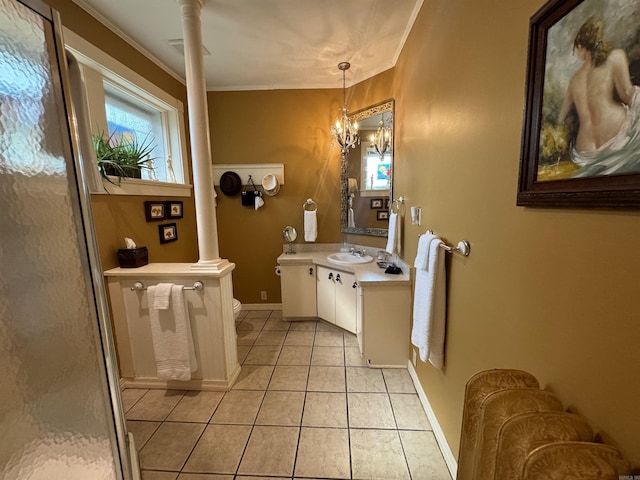 bathroom with tile patterned floors, ornate columns, vanity, an inviting chandelier, and toilet