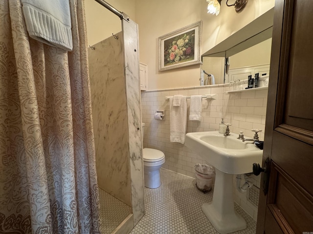 bathroom with tile patterned floors, toilet, tile walls, and a shower with shower curtain