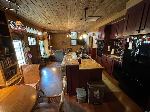 kitchen featuring wood ceiling, ceiling fan, black appliances, pendant lighting, and a center island