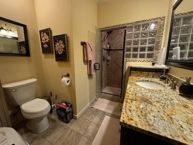 bathroom with vanity, toilet, and an enclosed shower