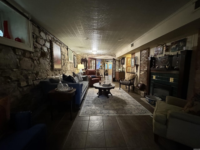 living room featuring a fireplace and crown molding