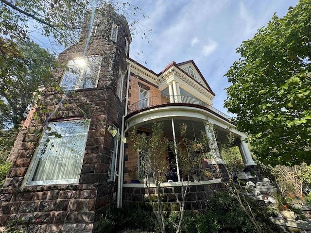 view of side of property with a balcony