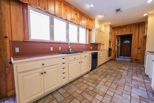 kitchen featuring tasteful backsplash, sink, and black appliances