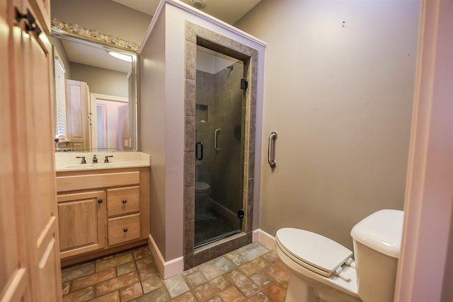 bathroom featuring walk in shower, vanity, and toilet