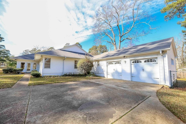 view of side of property with a yard and a garage