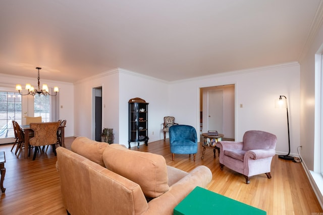 living room with hardwood / wood-style flooring, a notable chandelier, and ornamental molding