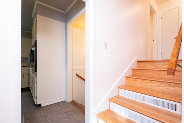 stairway featuring tile patterned flooring