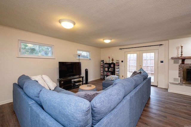 living room with french doors, a textured ceiling, and dark wood-type flooring