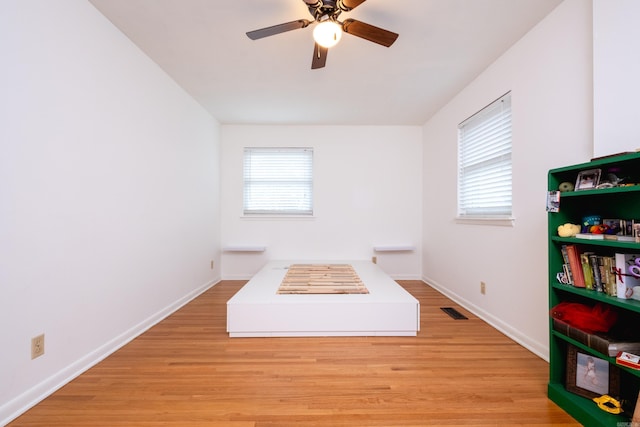 unfurnished bedroom featuring ceiling fan and light hardwood / wood-style floors