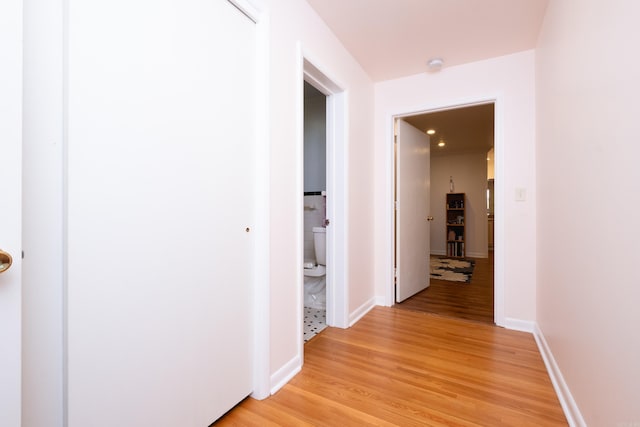 hallway with light hardwood / wood-style floors