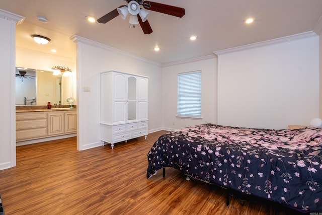 bedroom featuring dark hardwood / wood-style flooring, ceiling fan, crown molding, and ensuite bath