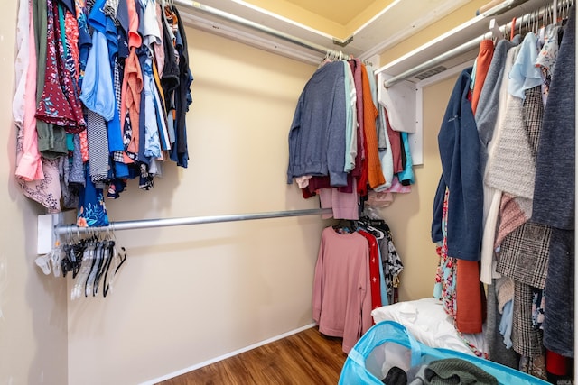 spacious closet with dark hardwood / wood-style floors