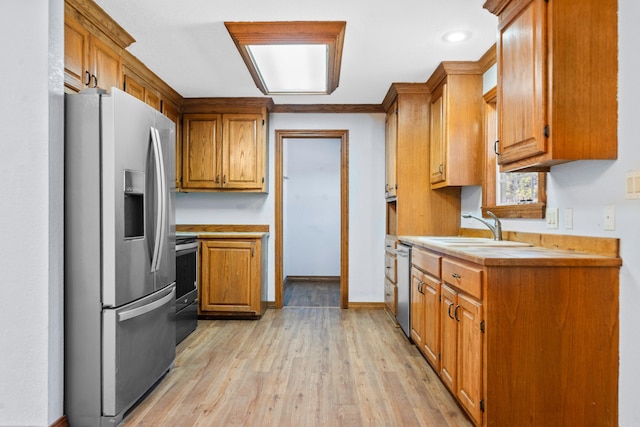 kitchen featuring sink, stainless steel appliances, and light hardwood / wood-style flooring