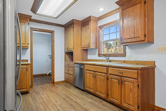 kitchen featuring light wood-type flooring, stainless steel appliances, and sink