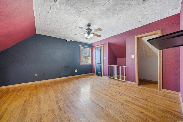 additional living space featuring ceiling fan, hardwood / wood-style floors, and lofted ceiling