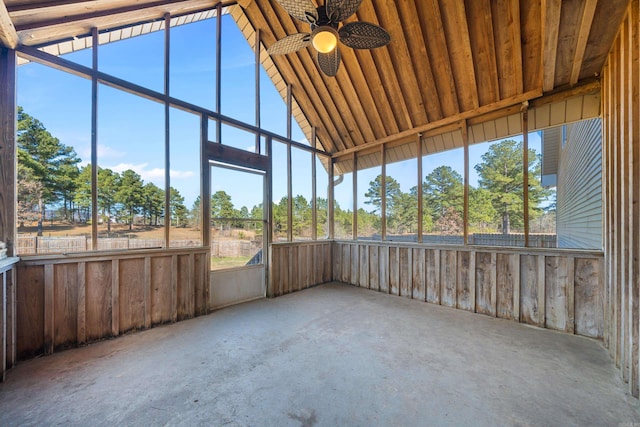 unfurnished sunroom featuring ceiling fan and vaulted ceiling